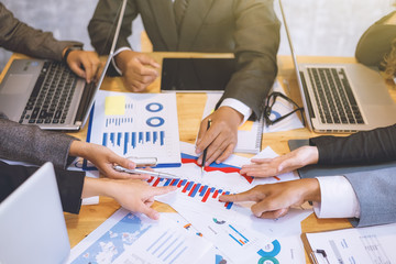 Good Business teamwork analyzing income charts and graphs with Successful Meeting in office. Close...