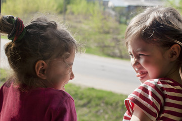 The girls joke and laugh. Good relations between the eldest and the youngest child.