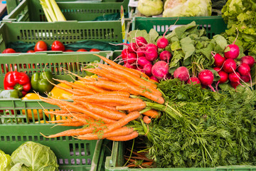 Carrots, radish and other vegetables for sale on a market