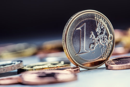 One euro coin on the edge. Euro money currency. Euro coins stacked on each other in different positions.