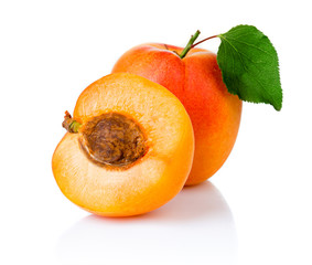 Ripe apricot fruits with with green leaf and slice isolated