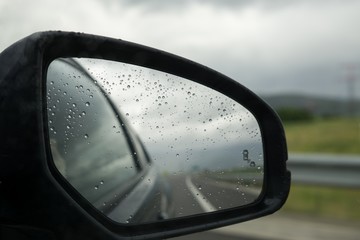 Raindrops on car mirror. Slovakia