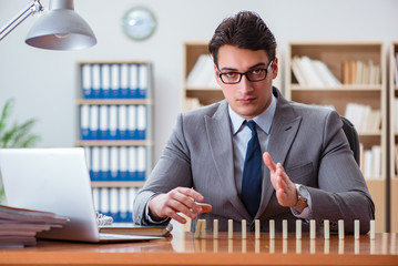 Businessman with dominoes in the office