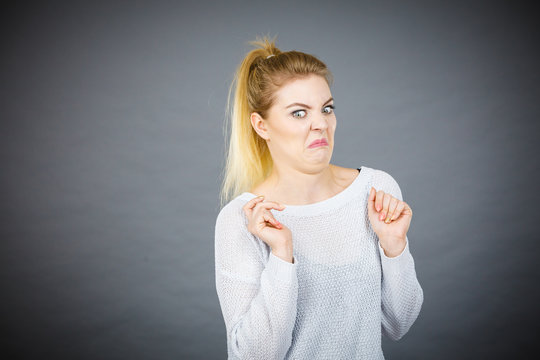 Disgusted woman having funny face expression