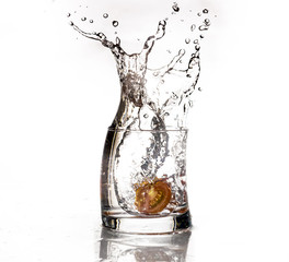 Tomato slice falls in a glass of water - Splash