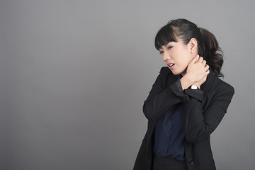 Business Woman Neck pain on grey background