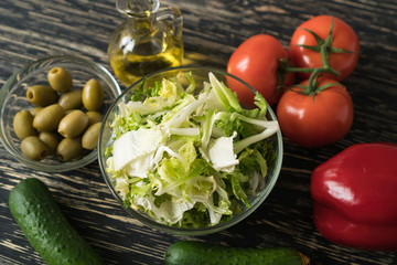 Salad ingridients. Tomato, lettuce, paprika, cucumber and olive oil.