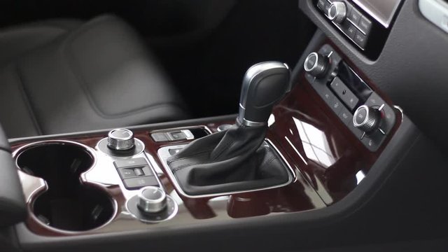 Interior of car inside, view of new automobile interior, steering wheel, gear box, control panel, leather interior and mahogany, auto sales in showroom,