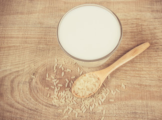 Rice milk on the wooden background .