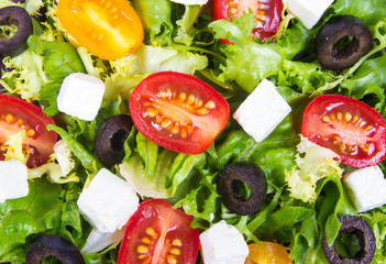 Greek salad with fresh vegetables, feta cheese and black olives.