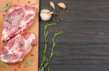 fresh raw meat with spices on wooden table. top view with copy space