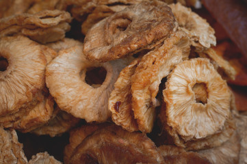 Dry pineapple slices ready to eat. Pineapple for sale on market. Agriculture background. Top view. Close-up