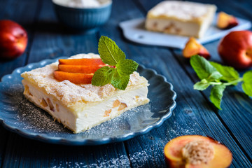 Dessert made of two puff pastry layers filled with mascarpone cream and nectarine
