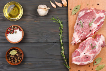 fresh raw meat with spices on wooden table. top view with copy space