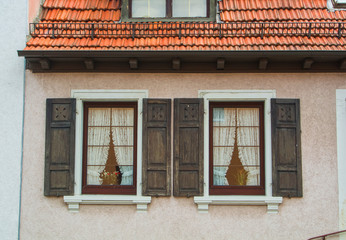 WALLDORF, GERMANY - JUNE 4, 2017: A close-up of german village residential house, its windows with old wooden shutters and tile roof.