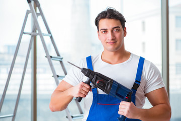 Young worker with hand drill