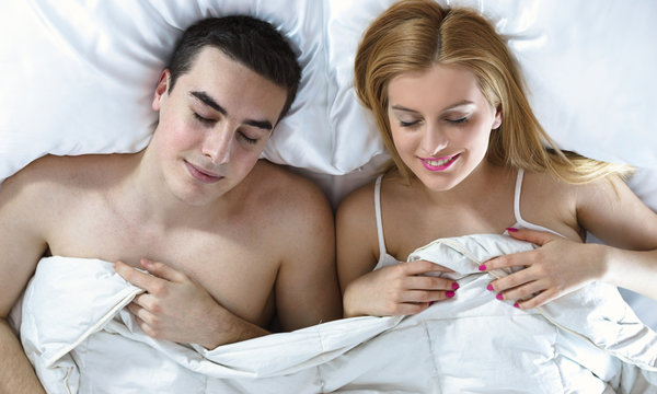 happy young couple sleeping in bed