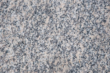 A marble background with small spots of black and white colors