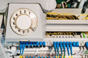 Conceptual photo - old retro phone on a rack with internet routers