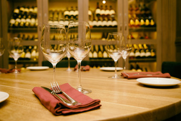 Restaurant table with wine fridge in the background, toned