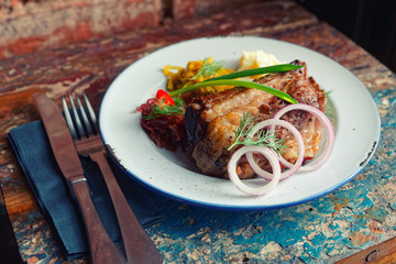 Grilled pork ribs on old peeled painted surface, toned