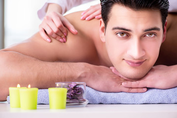 Obraz na płótnie Canvas Handsome man in spa massage concept