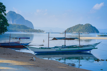 Fototapeta na wymiar Traditional banca boat at sandy Corong Beach in El Nido, Philippines