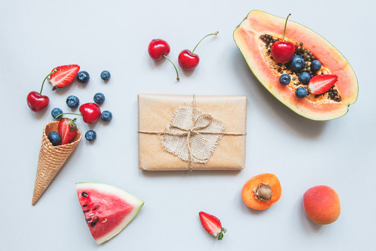 Cute Gift Box Wrapped With Craft Paper And Summer Fruits Top View. Summer Gift