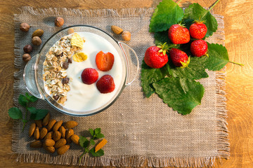 Yoghurt and muesli with nuts and strawberries for Breakfast. Healthy eating.