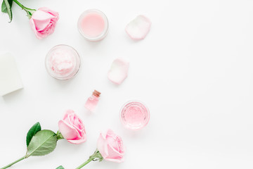 spa set with rose flowers and cosmetic for body on white desk background top view mockup