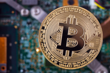 golden bitcoin and  computer chip in background