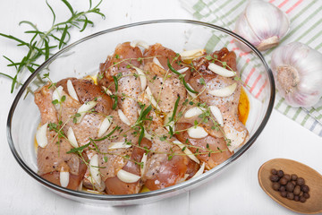 Marinated chicken. Raw chicken leg marinated with soy sauce, garlic, spices and herbs. Close-up.