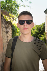 portrait young guy with sunglasses posing on the street vintage men, fashion men, hipster street