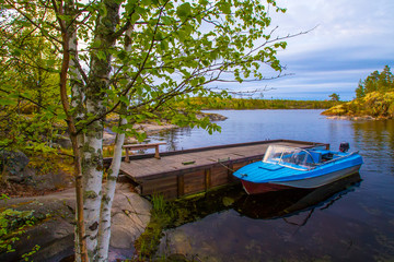 Naklejka na ściany i meble Boat at the pier. Motor boat at the pier. Karelia. Ladoga lake.