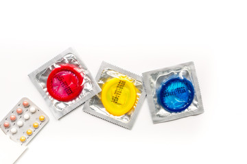 condoms and pills for male contraception and birth control white background top view