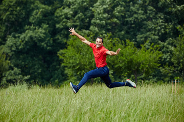 Fototapeta na wymiar Happy man jumping for joy