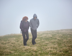 Hiking on mountain through fog