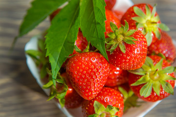 Ripe red strawberries. Bowl filled with juicy fresh ripe red strawberries. strawberries on a wooden table. Fresh strawberries. healthy food photo