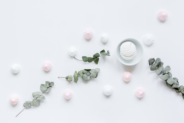 sweet lunch with marsh-mallow and spring flowers for woman on white background top view