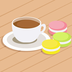 Coffee and three different colored macaroons on table