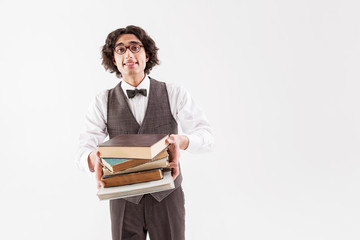 Cheerful clever student holding heap of volumes