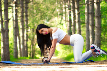 a young girl goes in for sports ,fitness training outdoors in a Park , girl in white tights , workout in the Park