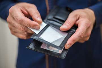 Bank card, business card, wallet, businessman holds in his hands and put the card in your wallet