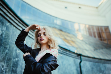 Fashion portrait of young elegant blonde woman outdoors.