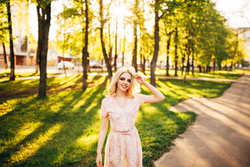 Portrait of young beautiful happy girl on background of the summer forest