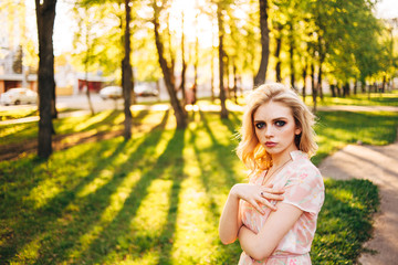 Portrait of young beautiful happy girl on background of the summer forest