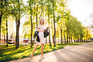 Portrait of young beautiful happy girl on background of the summer forest