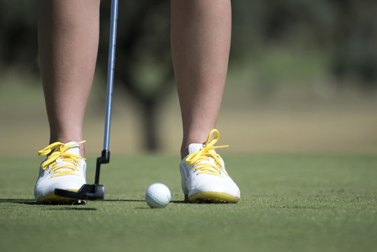closeup image of feet of a girl playing golf