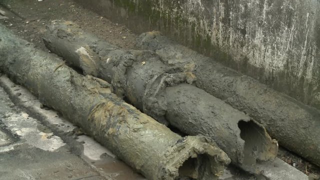 Broken and dirty water pipes on the road. Renovation of underground water pipes in a street in Taipei, Taiwan.  