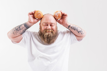 Man holding two doughnuts